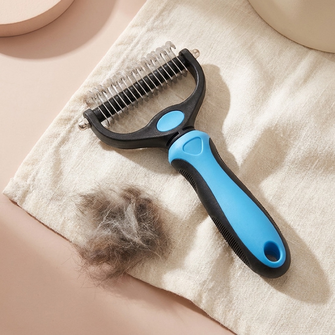 The comb resting on cream linen beside collected fur