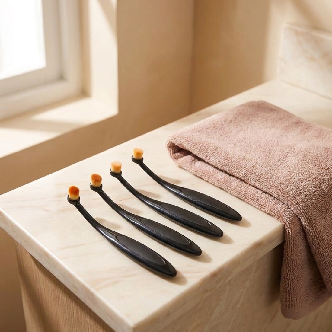 Three brushes arranged on a bathroom counter
